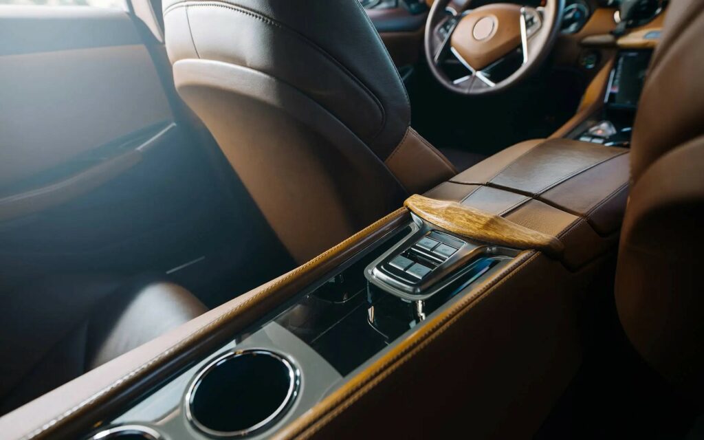 Luxury car interior with sleek center console and leather seats.